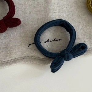 Detailed macro view of vintage ribbed cotton fabric scrunchies with bunny ear bow knots
