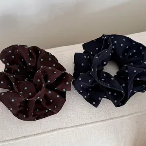 Vintage polka dot scrunchies set in blue and brown fabric for high ponytail hair styling