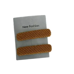 Pair of caramel brown twill knit hair clips set on a display card for women
