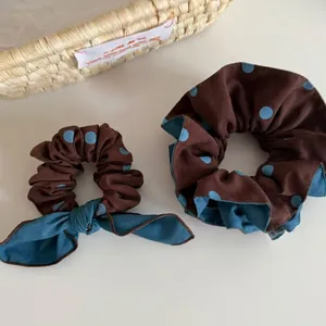 Brown polka dot scrunchie set with bow detail and light blue lining for women