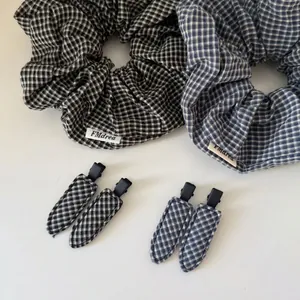 6-piece plaid fabric hair accessory set including scrunchies and hair clips in black and blue