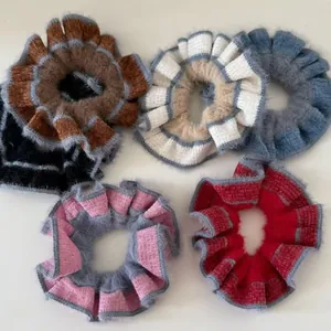 Detailed close-up showing soft fuzzy texture and gray scalloped edges of knit scrunchies