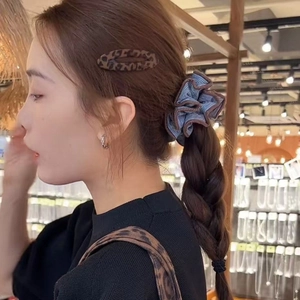 Blue striped scrunchie and leopard hair clip set on long brown hair ponytail