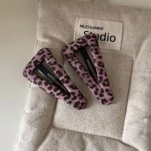 Set of two stylish pink leopard print BB hair clips for women on a quilted fabric base