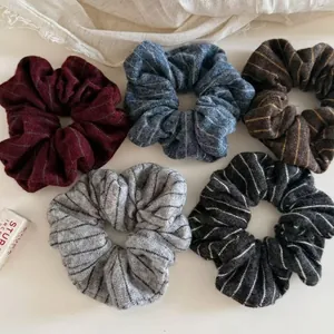 Five-piece set of knitted striped scrunchies in autumn tones like burgundy and grey