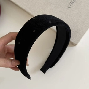 Elegant wide black velvet headband with subtle polka dots and soft sponge padding