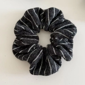 Detailed view of striped knitted scrunchie fabric texture in black and white pattern