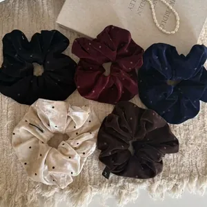 Lot de 5 chouchous en velours à pois aux couleurs variées sur un fond en maille beige