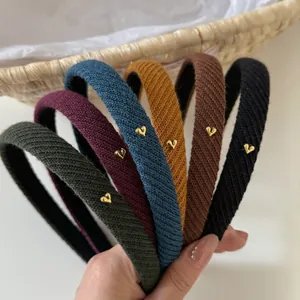 Close-up of knitted headbands with heart metal details in six assorted colors