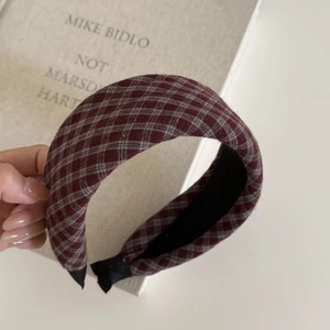 Detail of vintage plaid headband with thick padding and red-grey checkered cotton fabric