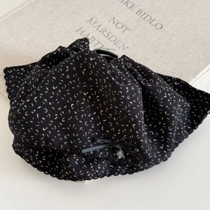 Elegant black floral fabric hair claw with ribbon bow and crystal pendant detail