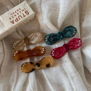 Set of 5 vintage acetate bow hair clips with rhinestone accents in assorted marble patterns