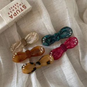 Five-piece vintage acetate bow hair clips with rhinestones and marble texture