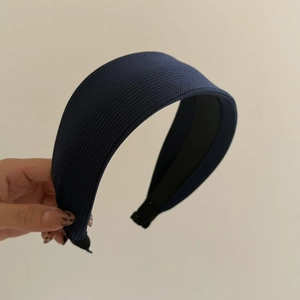 Navy blue knitted wide headband for women featuring a stylish high-top design and texture