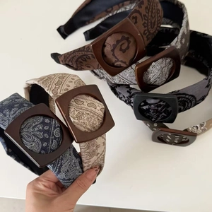 Close-up of paisley printed headbands with vintage square buckle detail in varied colors
