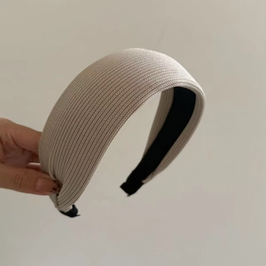 Detail view of beige ribbed knit headband with non-slip lining for women and girls