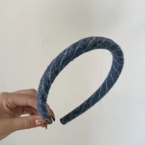 Detail of navy blue striped knit headband with French vintage thick textured fabric