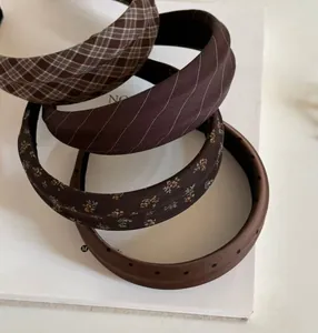 Set of four brown vintage headbands featuring plaid, twill, floral and polka dot patterns