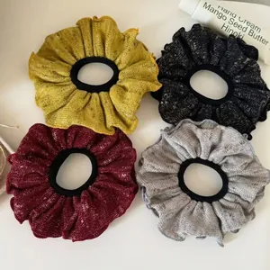 Set of four ruffled fabric scrunchies in yellow, black, burgundy, and grey knit textures