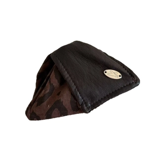 Brown leather hair accessory with leopard lining and oval bow metal logo ornament
