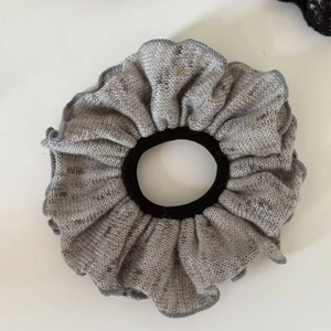 Elegant grey knitted oil painting style scrunchie with ruffled edges and high elastic core