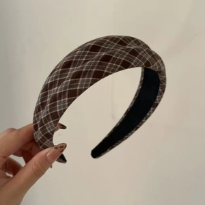 Detail showing vintage brown plaid headband with non-slip lining and fabric texture