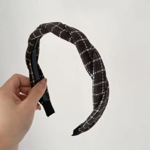 Detailed texture of thick grey wool plaid headband with non-slip toothed inner grip