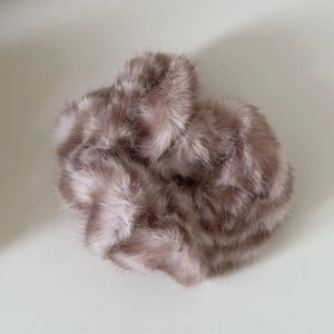 Macro shot of fluffy mauve faux fur scrunchie with soft plush texture for hair