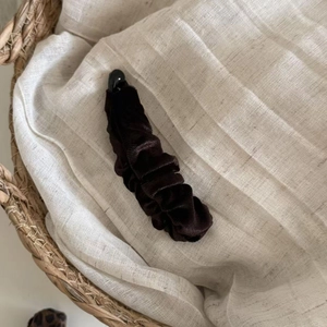 Close-up of vintage brown velvet banana hair clip with pleated scrunchie texture