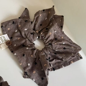 Oatmeal-toned polka dot bow hair scrunchie with wooden button and lace details