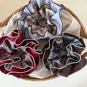 Three Korean style blue plaid double-layer scrunchies set in a woven straw basket