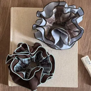 Close-up of vintage blue and brown checkered layered fabric hair scrunchies on a book