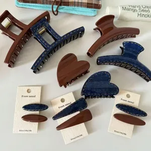 Brown and denim blue hair claw clip set with square and heart shapes on white backdrop