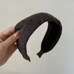 Detail view of the brown wool fabric texture and black inner lining of this wide headband