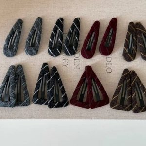 Flat lay showing assortment of textured striped fabric drop and triangle BB hair clips