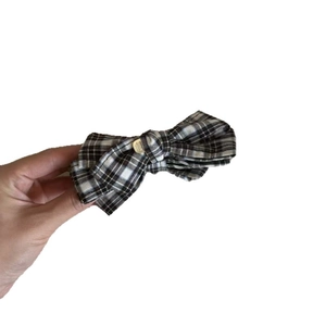 Classic plaid bow banana hair clip in brown and beige with a gold metal center