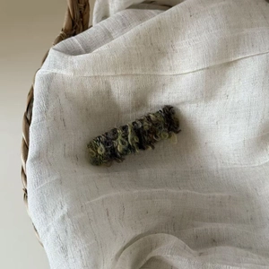 Sweet knitted plush hair clip for women with earthy green and cream wool textures