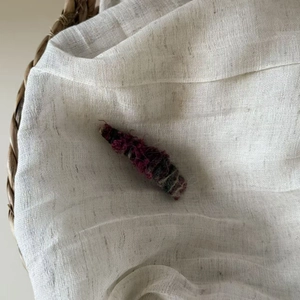 Detailed close-up of handmade woven plush hair clip showing texture and soft yarn fabric