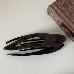 Detailed macro view of the tortoiseshell patterns on the acetate hair clip for women