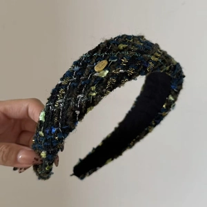 French tweed headband with wide knit pattern and decorative gold metal brand plate