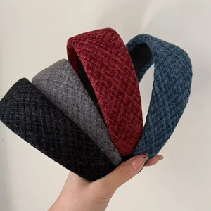 Close-up of thick wool headband set in black, gray, red, and blue woven textures