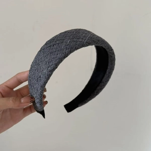 Detail of grey tweed wide headband showing the woven texture and retro minimalist style