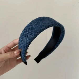 Detail view of blue tweed braided headband with black non-slip lining and thick design