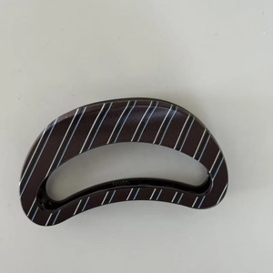 Brown striped curved hair claw clip with crescent shape and glossy resin finish