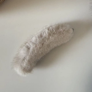 Close-up of light grey faux mink fur banana clip hair accessory with soft texture