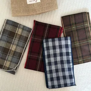 Set of vintage plaid silk scarf necklaces in multiple colors on a soft plush background
