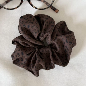 Chic leopard print satin scrunchie with soft silk texture for trendy hairstyles