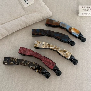 Collection of five acetic acid banana hair clips in marble and tortoiseshell patterns