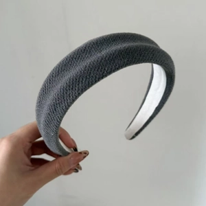 Close-up of the grey knitted wool texture and inner lining of this wide padded headband