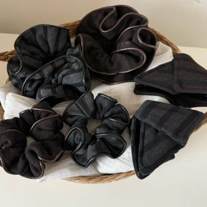 Vintage style striped knit hair scrunchies and headbands in a woven basket display